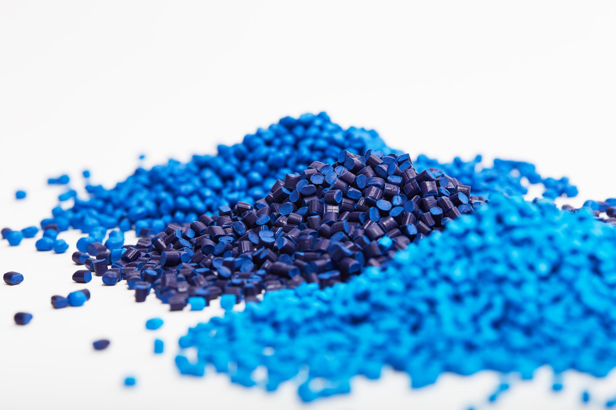 high-angle-view-blue-plastic-granules-white-background_1048944-7274870