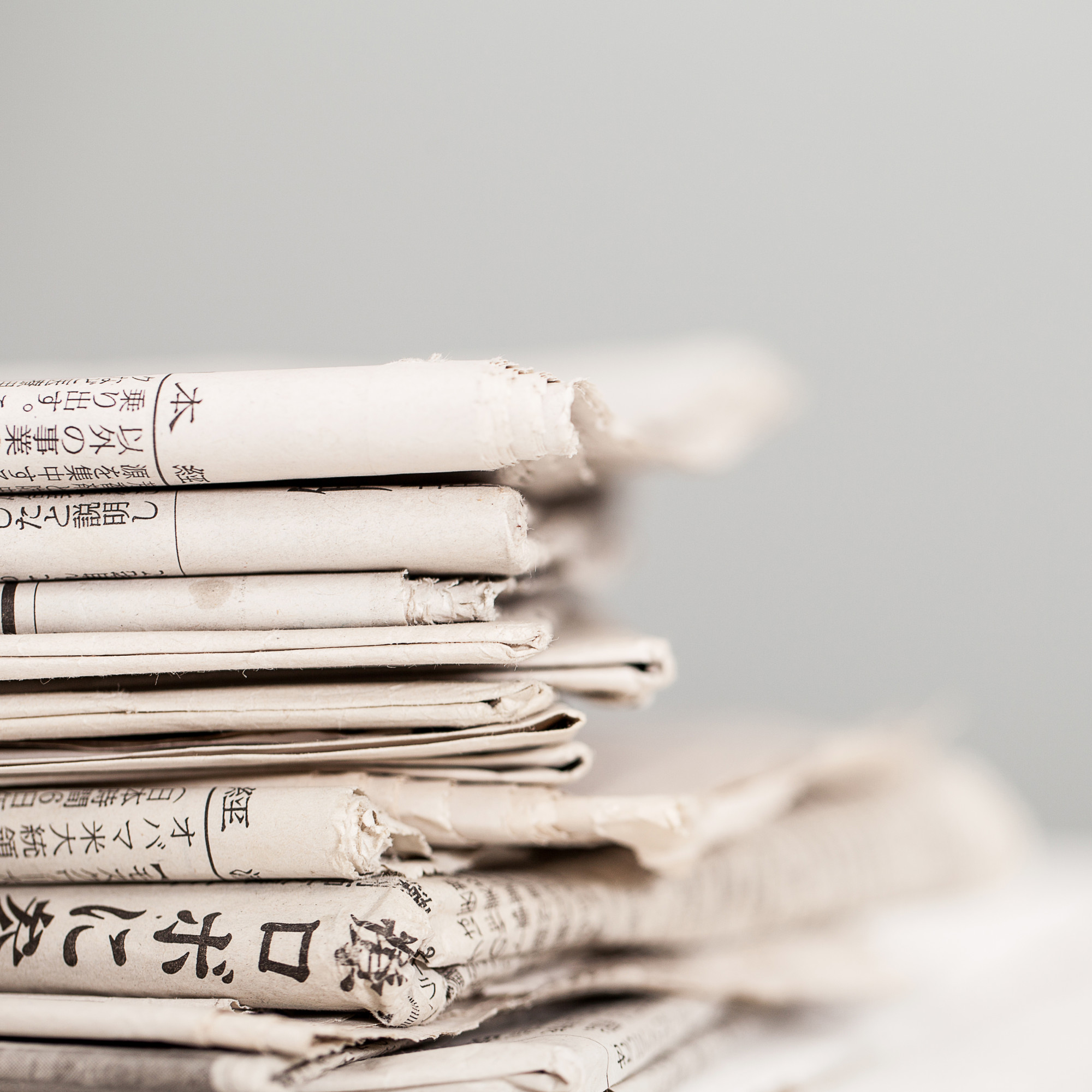 pile-newspapers-white-table_144627-3782